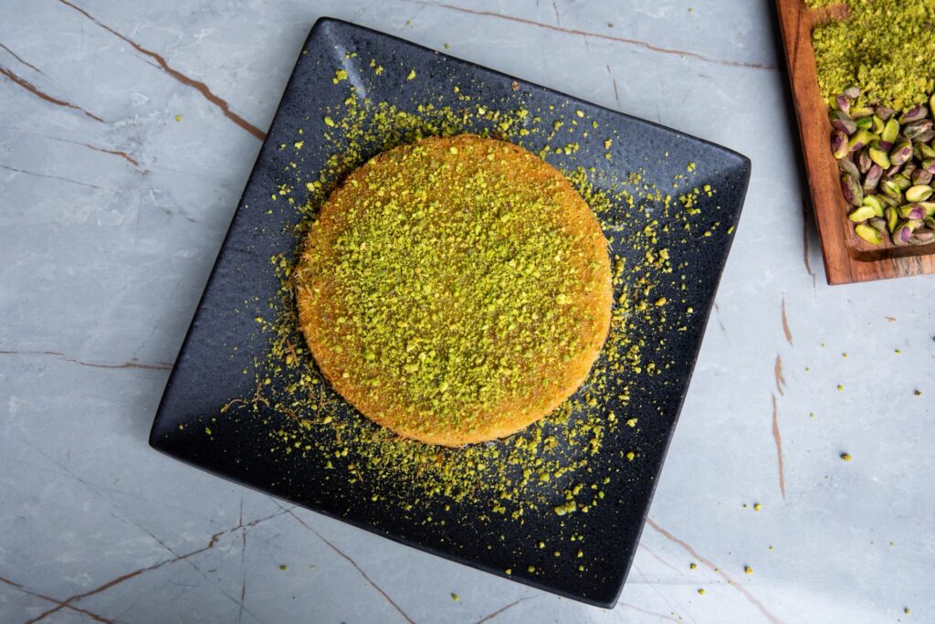 Overhead view of Vavela's knafeh dusted with crushed pistachio